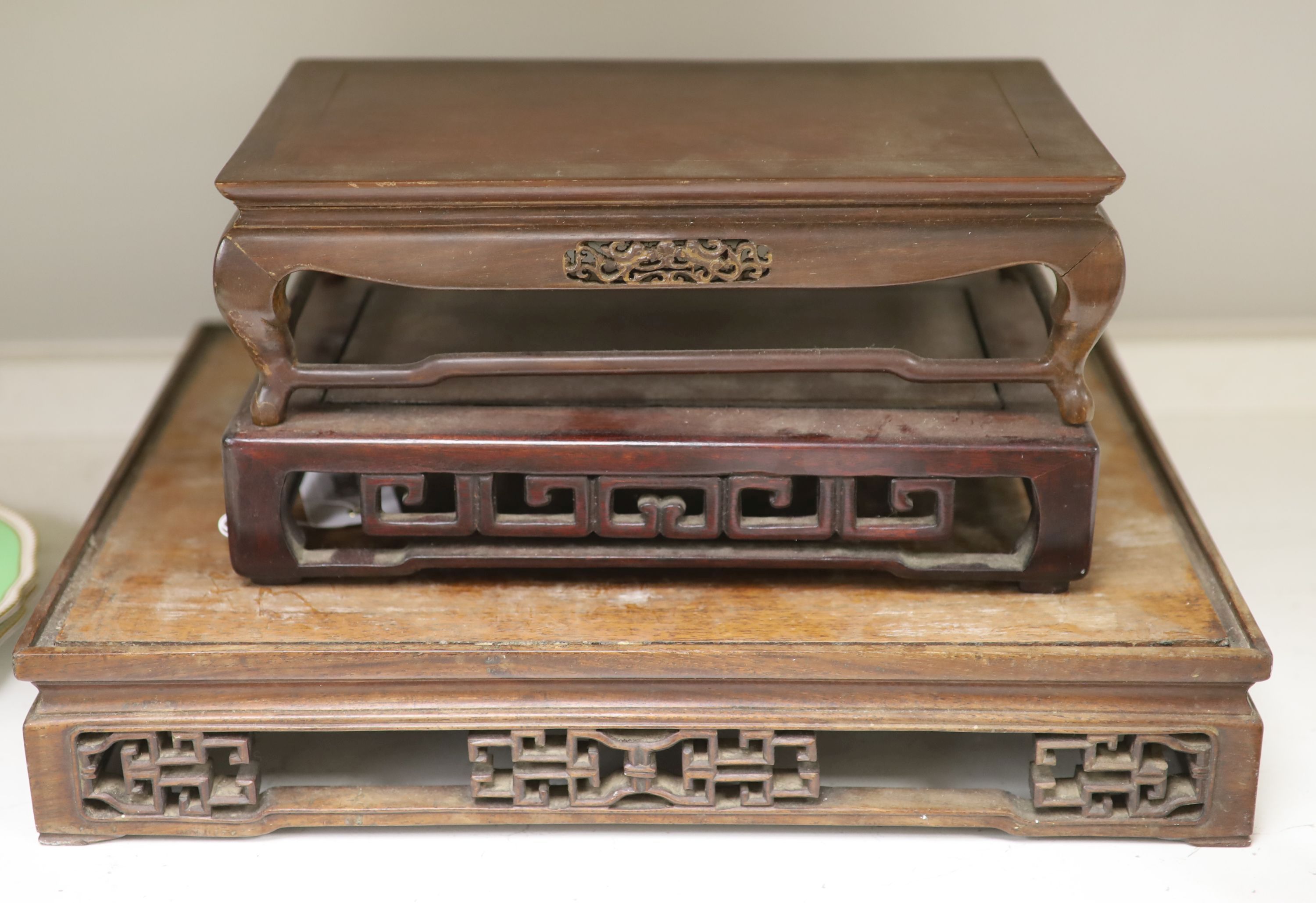 Three Chinese hardwood stands, 19th/20th century, largest 42.5 x 32cm